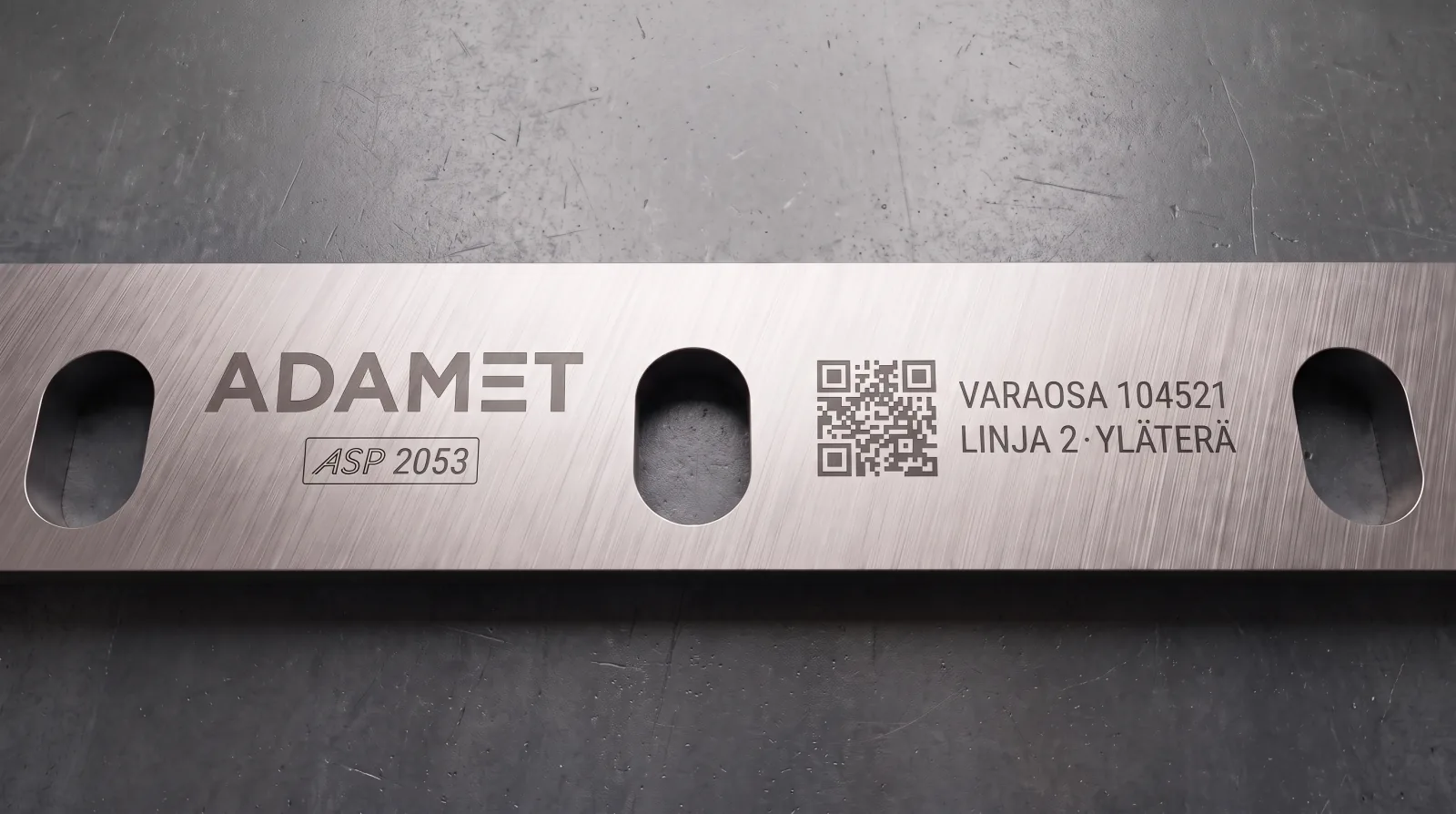 Markings etched on the side of a blade: Adamet logo, QR code, spare part number, line ID and ASP 2053 material stamp